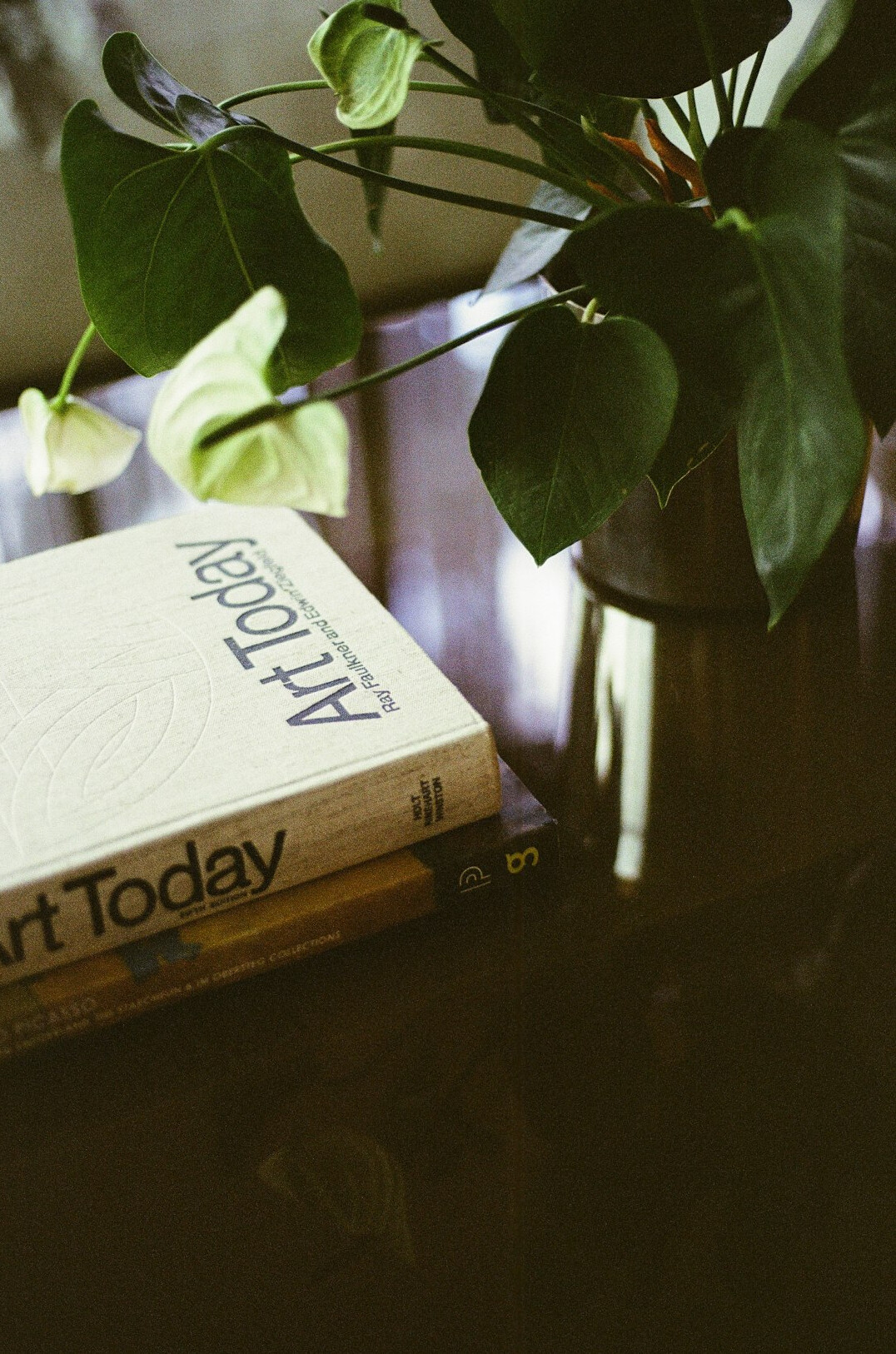 Stack of books and a notebook on a table