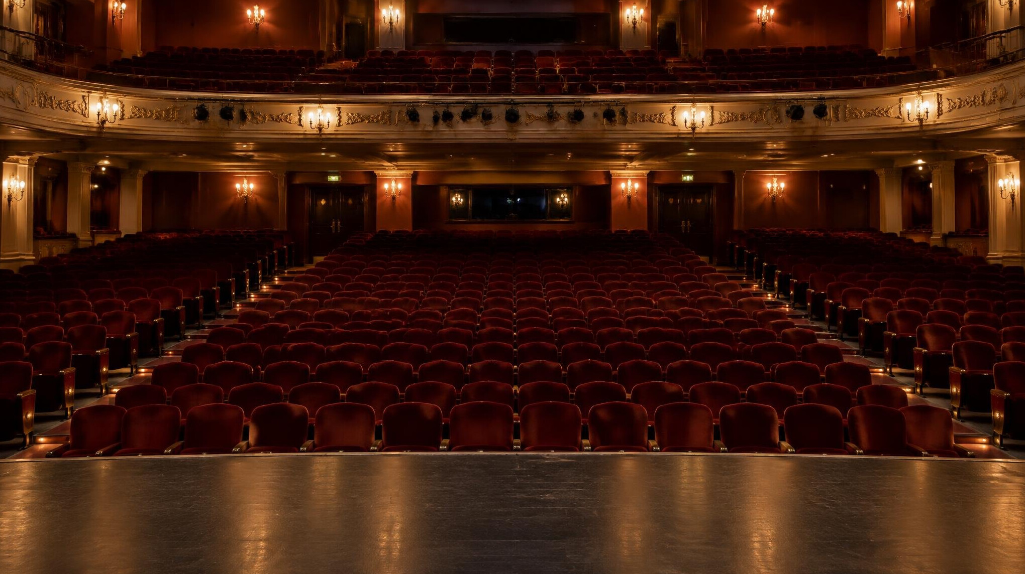 Empty red theatre seats in a quiet auditorium
