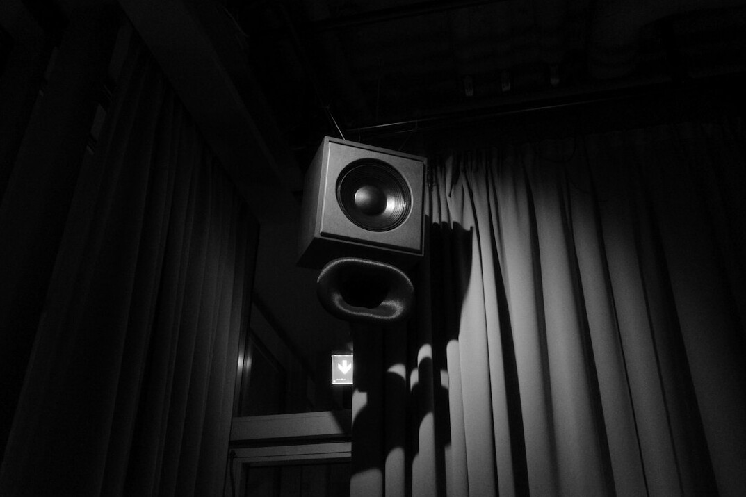 Theater stage with heavy curtains and a single spotlight